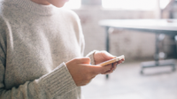 A photo of a high school student using a smartphone.