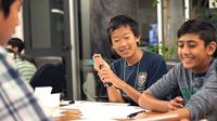 Three boys working together around a table