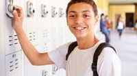 Boy at his locker outside hallway