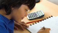 A boy works on a math problem.