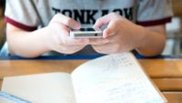 Close-up of a student’s hands holding a smartphone