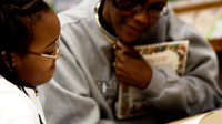 Woman and girl reading together