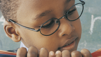 A photo of a young boy reading a book.