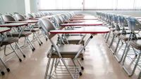 Neat rows of desks fill a classroom.