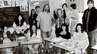 Teacher standing among his students in the classroom