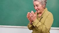 photo of a woman in front of a chalkboard