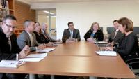 photograph of people around a conference room table