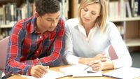 A student and teacher discuss the student’s college essay.