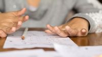 Photo of a girl’s hands as she uses her fingers to do math