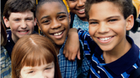Two girls and three boys standing together smiling