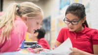Two young students discuss a poem.