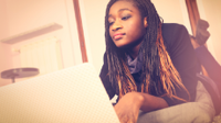 A photo of a high school female doing research on her laptop.