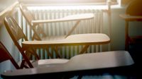 Close up of three metal folding chairs with table