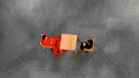 High, overhead view of two people sitting at a table on a patterned concrete floor with no one else around