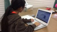 photo of a student working on a laptop