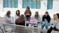 photo of a group of people sitting on benches in a circle