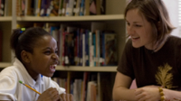 photo of a student and teacher sharing a laugh