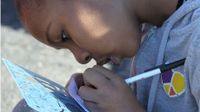 photo of a girl working with pen and ink