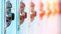 A closeup on 6 adjacent lockers. The first locker is clear and blue, each locker following gets more and more out of focus and shifts into reds and yellows, looking like a rainbow.