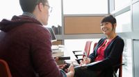 photo of two people seated across from one another