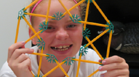 photo of a young woman with a spirograph-like toy