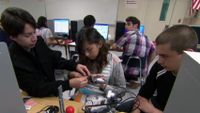 A group of students working on a computer/IT project.