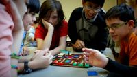 A group of students are working on their lego work.