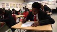 Students are working on their test in the classroom.