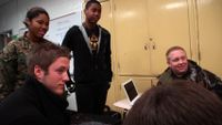 Students are listening to their friend in a discussion group