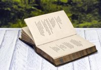 Antique book of poetry sitting on picnic table