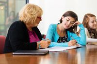 Teacher talking one-on-one with a student