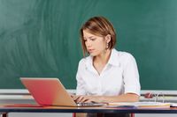 Teacher working on a laptop in her classroom