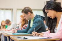 High school students writing in a classroom