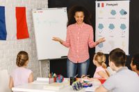 A French teacher instructing a class of middle school students