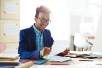A high school student looking over an essay he has written