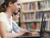 Students use laptops in the library