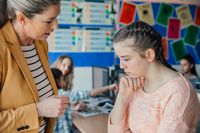 A teacher comforting a distressed student