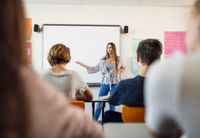 A high school student giving a presentation in front of her class
