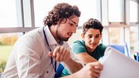 A teacher giving a student feedback about his writing