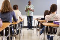 High school student giving presentation to his class.