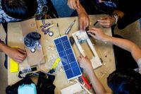 High school students working on a solar car project
