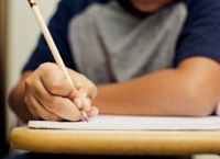 Male student writing a letter