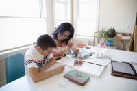 Mother helping her son with his homework