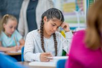 Middle school student reading at her desk