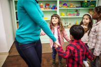 Teacher dancing with kindergarten students