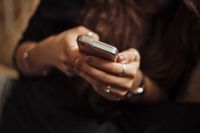 Tight crop of woman using a smartphone