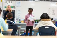 Elementary school student giving a presentation to her class