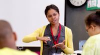 Young teacher instructing her class