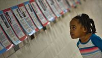 Elementary school student looking at a Black History Month display in a school hallway