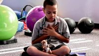 A child does relaxing breathing activities in a sensory space